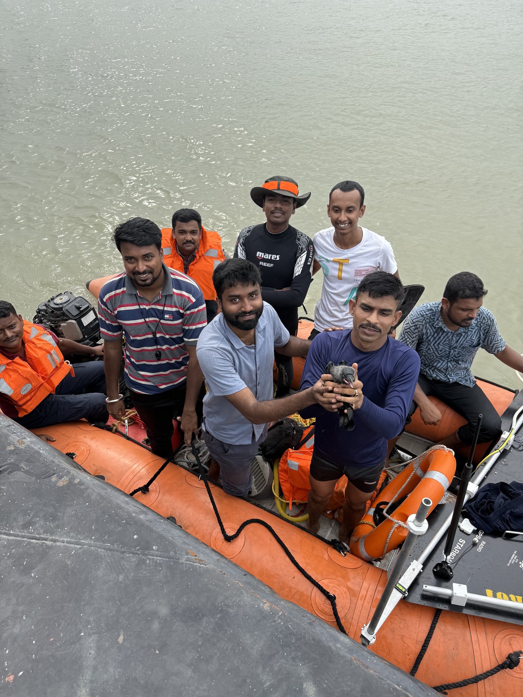 Civil Defence volunteers in a rescue boat on the water